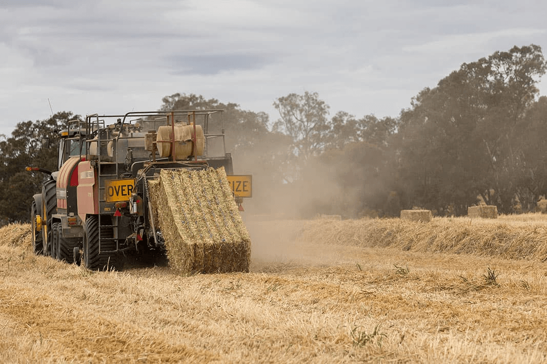 Hay baler harvesting in an Australian field.